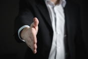 Man extending his hand for a handshake. - 700w