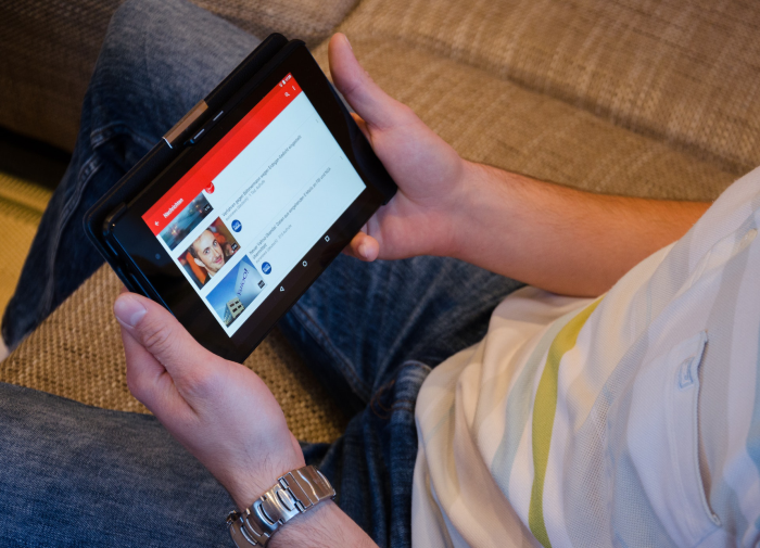 man watching bumper ads on tablet