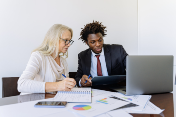 Real estate agents looking at a computer