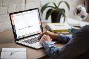 man researching on CEO using laprtop