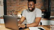 man typing on Laptop