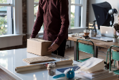 A person packing a box