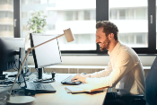 Man Using computer to learn PPC management for small business