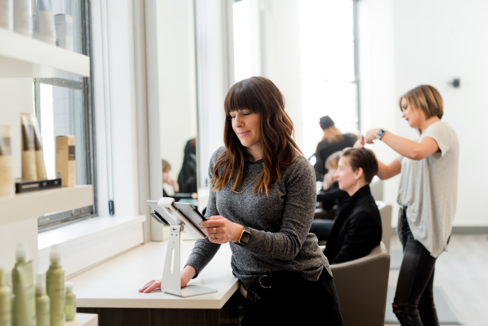 Small Business Marketing Coach holding tablet