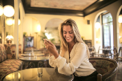 Woman reviewing social media accounts of Restaurant Marketing Companies using a mobile phone