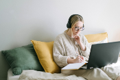 Woman using laptop and researching about Marketing SaaS Companies