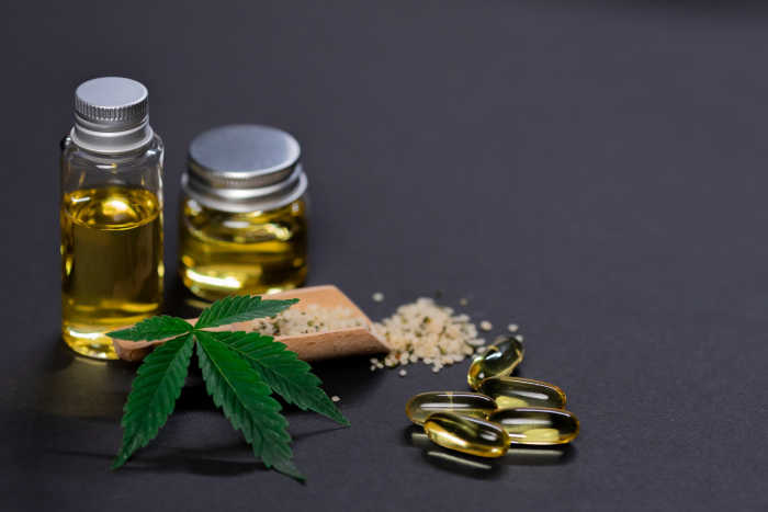 Marijuana leaves and oils sitting on a table