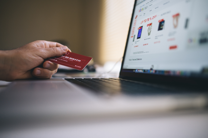 man using credit card to pay for eCommerce SEO Tools