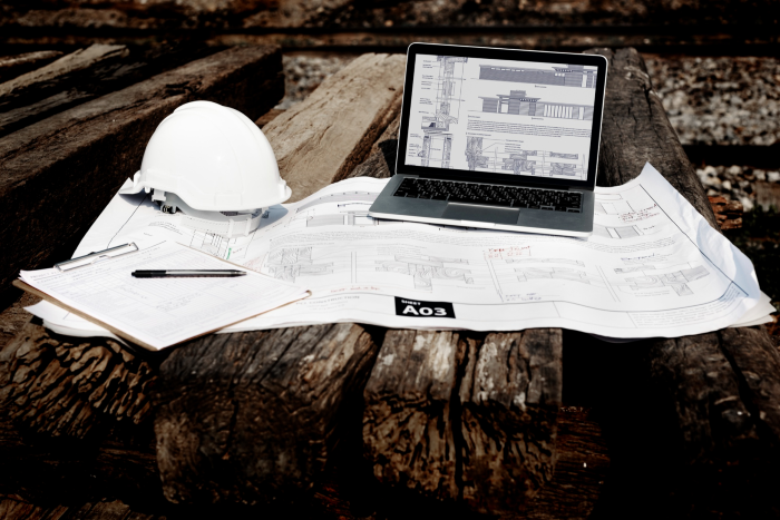 A computer in the construction site with Construction plan
