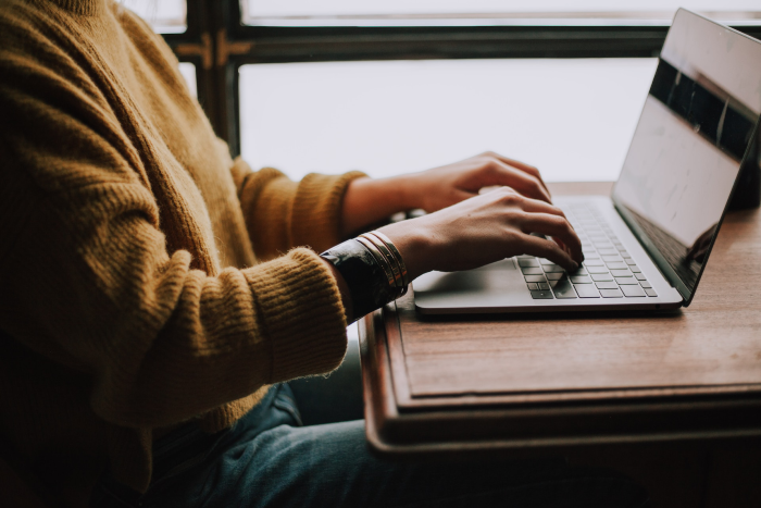 Woman working on a real estate PPC campaign on her computer