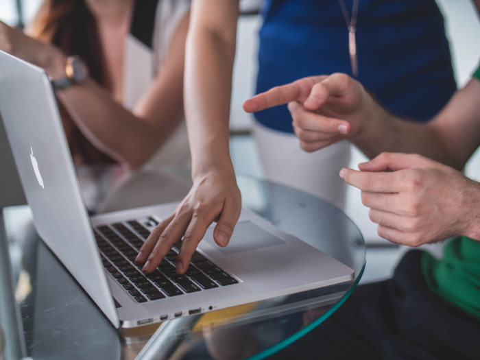 People pointing at a real estate PPC campaign on their computer