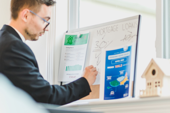 Real estate agent writing on a whiteboard